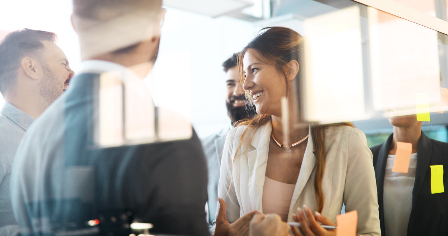 woman smiling and laughing with college at the office